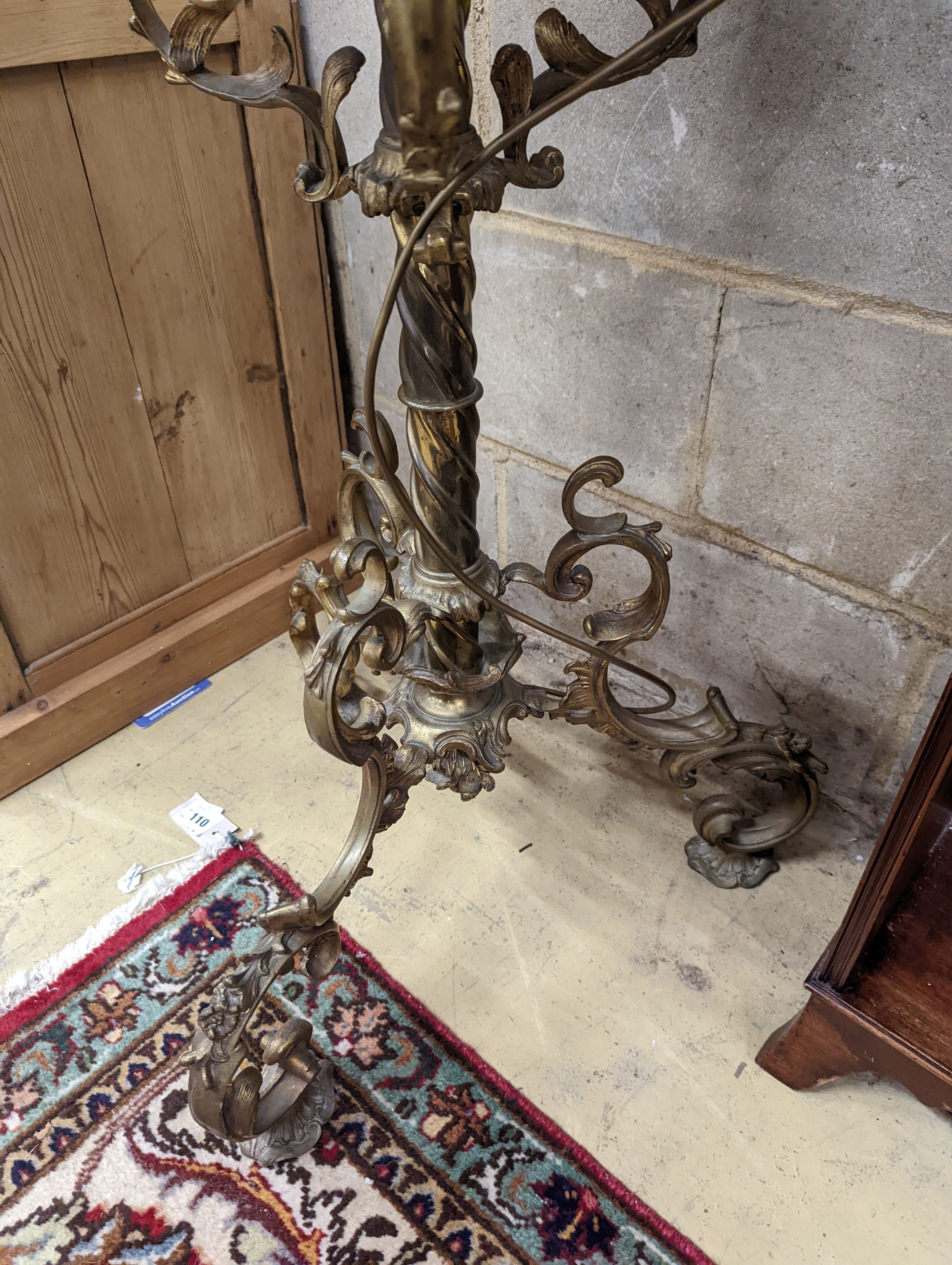 A late Victorian cast brass and onyx oil lamp standard, the column with an alabaster mid tier, raised on an open scrolled tripod base, converted to electricity, height 152cm